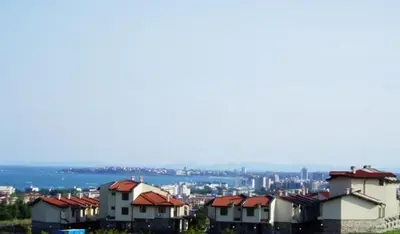 a group of houses with a city in the background at Dream Villa in Imperial Heights Villas in Sunny Beach