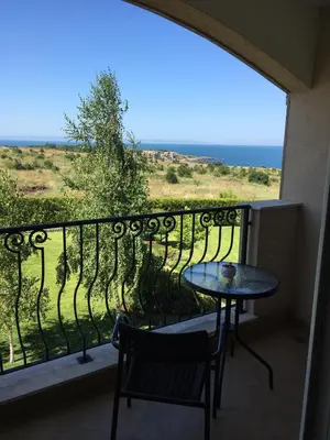 a balcony with a table and a view of the ocean at Apartments Atia Resort in Chernomorets