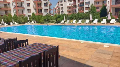 a swimming pool with chairs and a table in a building at COCO Coworking & Coliving in Aheloy