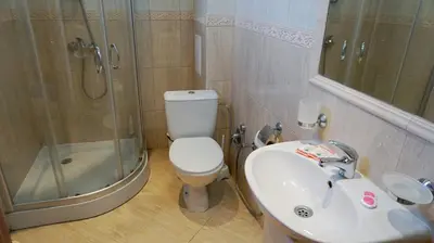 a bathroom with a toilet and a sink and a shower at Апартамент Атлантик Бяла - Apartment Atlantic Byala in Byala