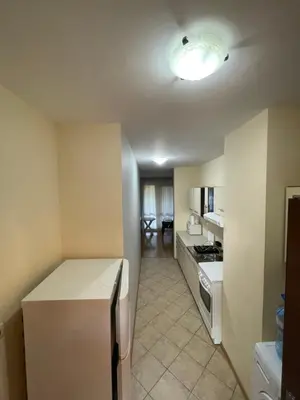 a small kitchen with a refrigerator and a stove at Galeria Holiday Apartments in Obzor