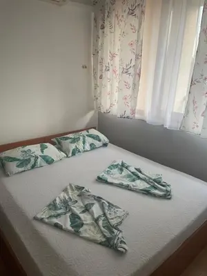two pillows on a bed in a bedroom at Galeria Holiday Apartments in Obzor