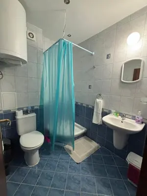 a bathroom with a toilet and a shower and a sink at Galeria Holiday Apartments in Obzor