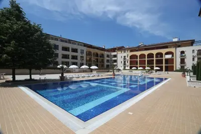 a large swimming pool in front of a building at Galeria Holiday Apartments in Obzor