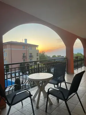a patio with a table and chairs on a balcony at Galeria Holiday Apartments in Obzor