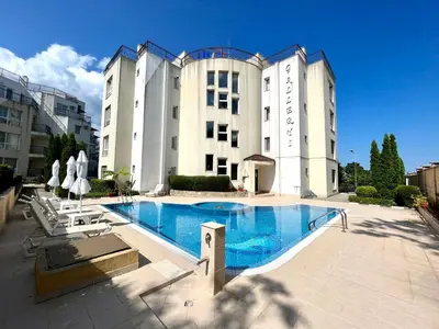 a large building with a swimming pool in front of it at Студио Галерия - Studio Galeria in Byala