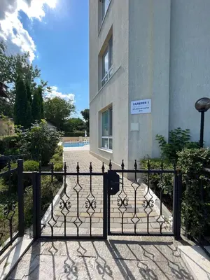 a black gate in front of a building at Студио Галерия - Studio Galeria in Byala