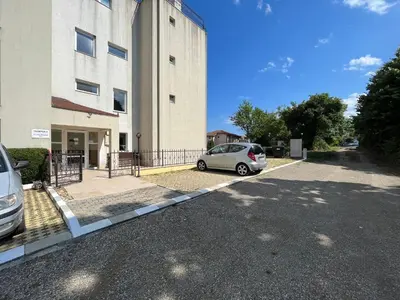 a car parked in a parking lot next to a building at Студио Галерия - Studio Galeria in Byala