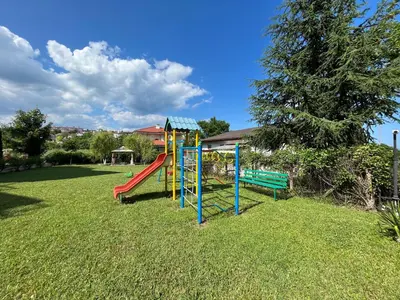 a playground with a slide in the grass at Студио Галерия - Studio Galeria in Byala