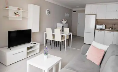 a living room with a couch and a table and a kitchen at DiP HOME APARTMENTS in Pomorie