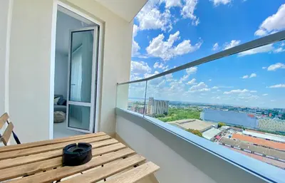 a balcony with a wooden bench and a large window at Arena MALL Galleria View and Securities Parking1 in Burgas City