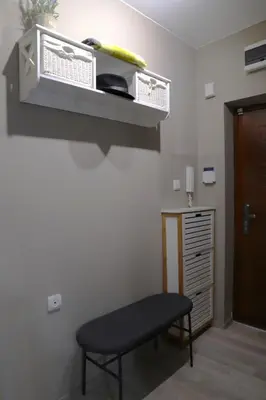 a room with a table and a chair in a room at Апартамент МАРГО in Burgas City