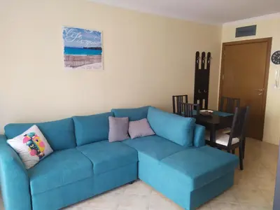 a blue couch in a living room with a table at Sea Bliss Retreat -Santa Marina - Sozopol in Sozopol
