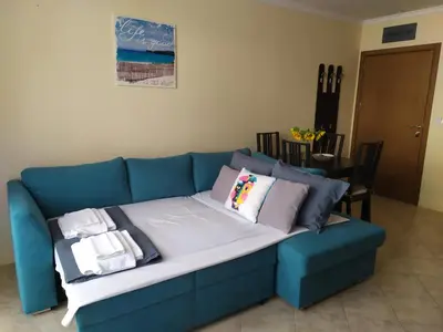 a blue couch with pillows on it in a living room at Sea Bliss Retreat -Santa Marina - Sozopol in Sozopol