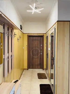 a hallway with a door in a building at Просторен апартамент in Varna City