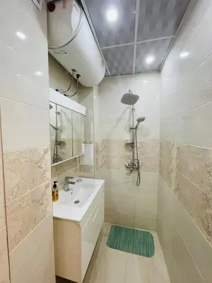 a bathroom with a sink and a shower at Просторен апартамент in Varna City