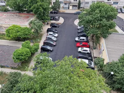 a bunch of cars parked in a parking lot at Просторен апартамент in Varna City