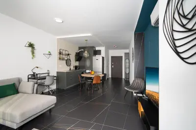a living room and kitchen with a couch and a table at Arena MALL Galleria View and Securities Parking2 in Burgas City