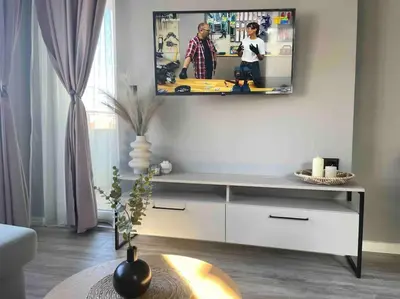 a living room with a flat screen tv on a wall at Villi’s Home in Burgas City