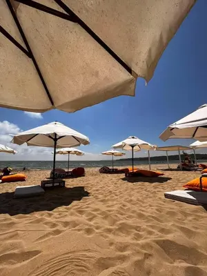 a group of umbrellas on a sandy beach at Sozopolis Hills - B1 - 3-room apart - 10 min from the beach in Sozopol