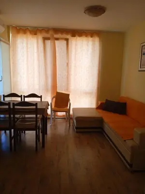 a living room with a couch and a table and chairs at APARTMENT 8 Primorsko АПАРТАМЕНТ 8 Приморско in Primorsko