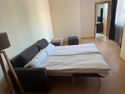 a bed in a room with a couch at Sunny Majestic Private Apartment in Sunny Beach
