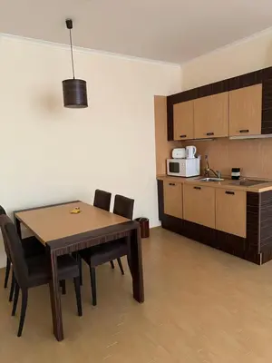 a kitchen with a table and chairs in a room at Sunny Majestic Private Apartment in Sunny Beach
