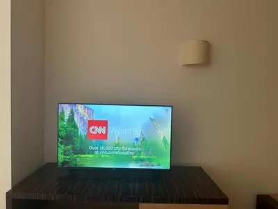 a flat screen tv sitting on top of a wooden table at Sunny Majestic Private Apartment in Sunny Beach