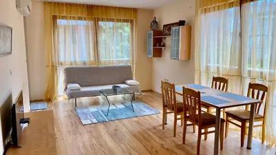 a living room with a table and a couch at Harmani Beach Apartment 4 in Sozopol