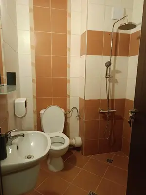 a bathroom with a toilet and a sink and a shower at Harmani Beach Apartment 4 in Sozopol