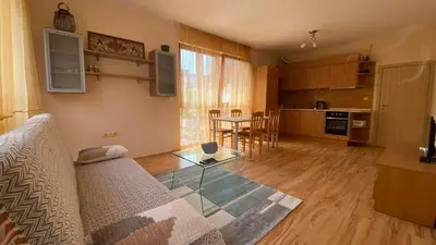 a living room with a couch and a table at Harmani Beach Apartment 4 in Sozopol