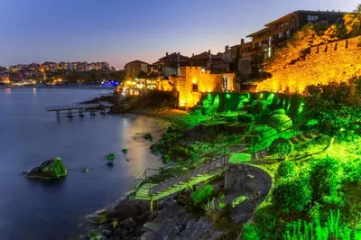 a view of a river with a city at night at Harmani Beach Apartment 4 in Sozopol