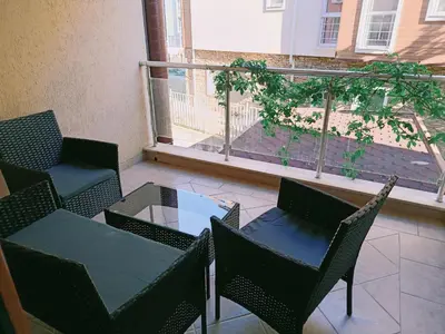 a patio with a table and chairs on a balcony at Harmani Beach Apartment 4 in Sozopol