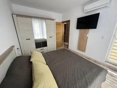 a living room with a couch and a flat screen tv at Aphrodite Park in Sunny Beach