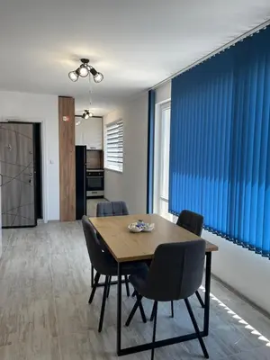 a dining room with a wooden table and chairs at Zagorovi -1 SP apartments in Burgas City