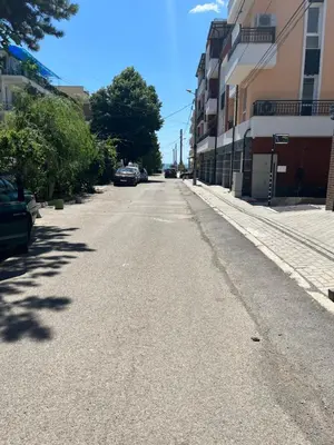 an empty street with cars parked on the side at Zagorovi -1 SP apartments in Burgas City