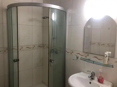 a bathroom with a shower and a sink and a mirror at Lovely 3 Room Apartment new furnished Kamelia Sunny Beach in Sunny Beach