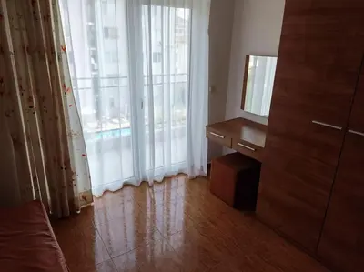 a living room with a desk and a large window at Billy's two- bed apart for Rent at Sunny Beach in Sunny Beach