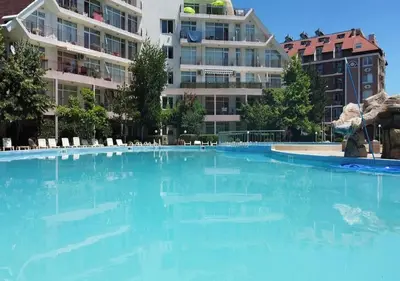 a large pool with blue water in front of a building at Billy's two- bed apart for Rent at Sunny Beach in Sunny Beach
