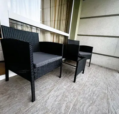 two chairs and a bench in a room at Studio Festa Pomorie in Pomorie