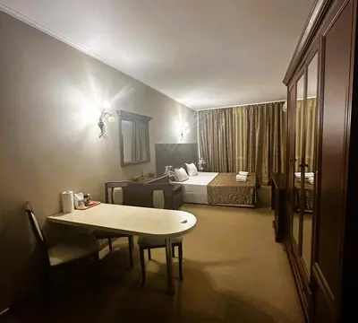 a hotel room with a bed and a table and a bedroom at Studio Festa Pomorie in Pomorie