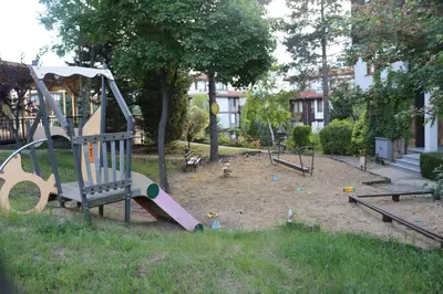 a playground with a slide in a park at 1 bedroom apartment in Santa Marina Sozopol in Sozopol