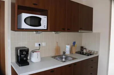 a kitchen with a sink and a microwave at 1 bedroom apartment in Santa Marina Sozopol in Sozopol