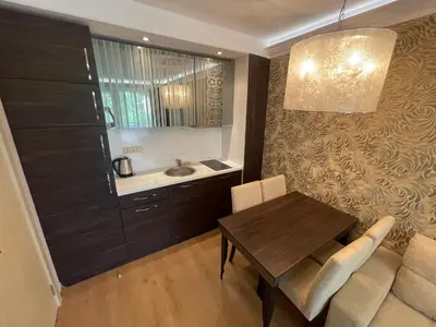 a living room with a table and a couch at Harmony Palace - Menada Apatments in Sunny Beach