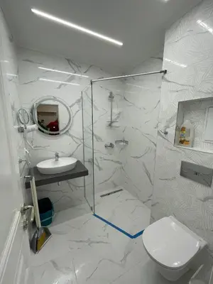 a white bathroom with a toilet and a sink at Golden leaf, swimming pool view in Ravda