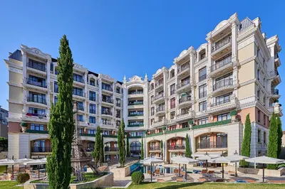 a large building with umbrellas in front of it at Florance Rentals Luxury Apartments in Saint Vlas in Sveti Vlas