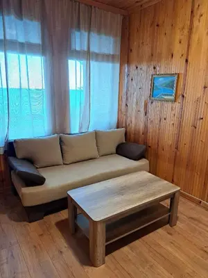 a living room with a couch and a coffee table at Комплекс Джулай Морнинг in Kiten