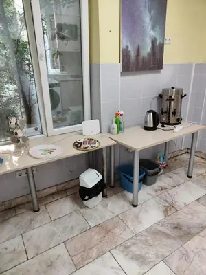 a bathroom with two tables and a coffee maker at ЛИДЕР ХАУС ХОСТЕЛ in Varna City