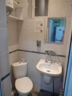 a bathroom with a toilet and a sink at ЛИДЕР ХАУС ХОСТЕЛ in Varna City