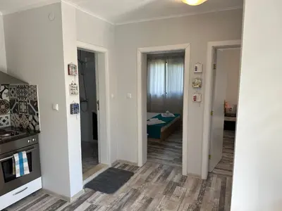 a hallway with a room with a bed and a kitchen at Villa Sea House in Byala